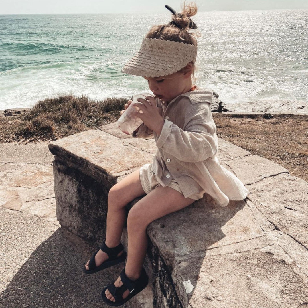 stylish child wearing fini palm visor light tone natural straw
