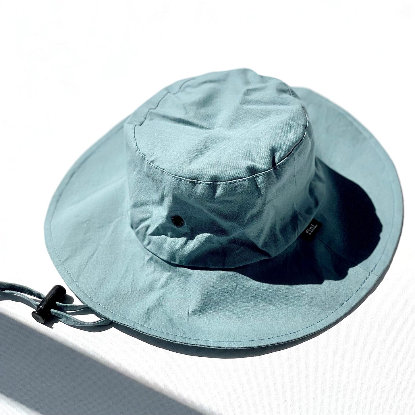WS_available now_FINI. HAT: fini. relaxed bucket hat - blue-fini. the label