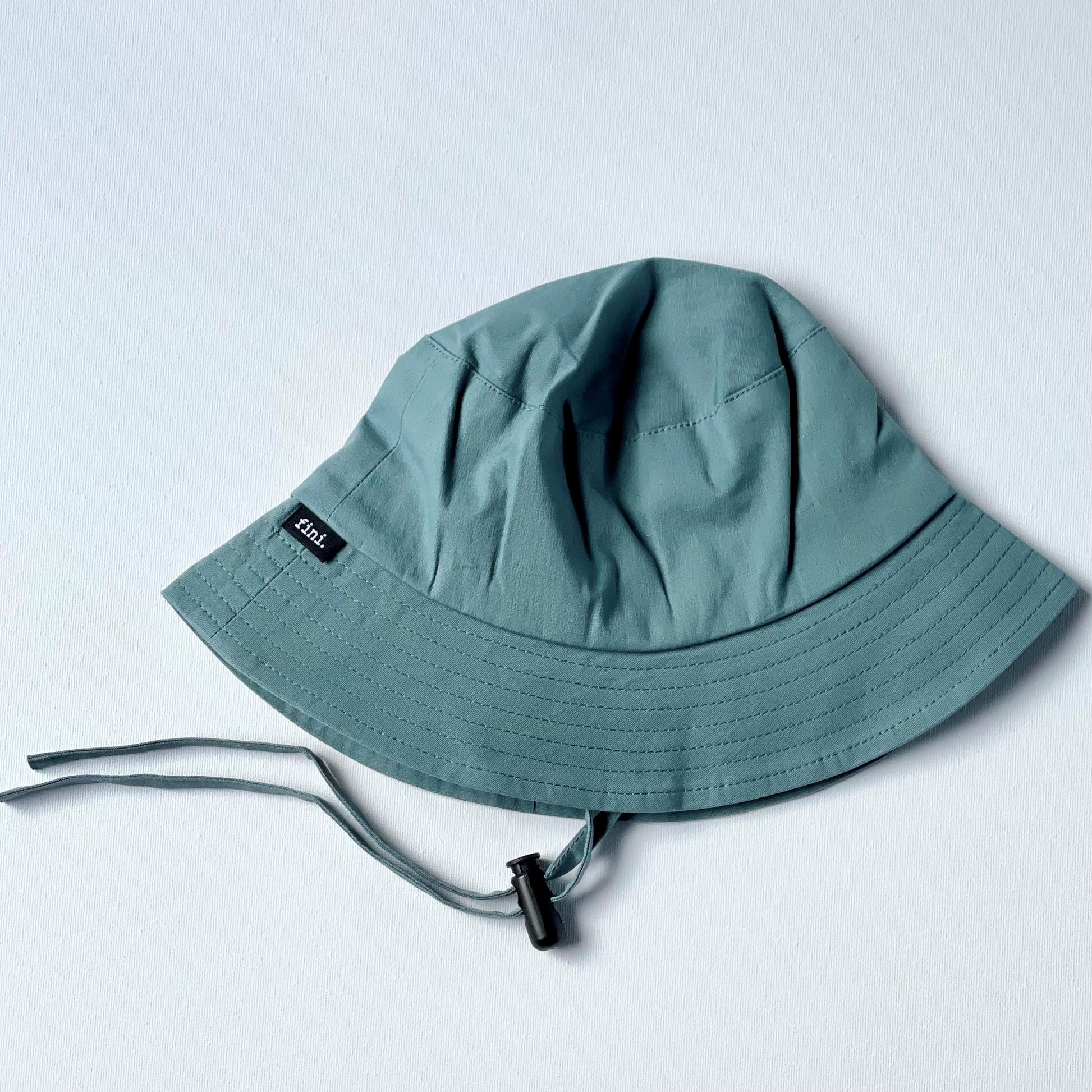 WS_available now__FINI. HAT: fini. bucket hat - blue-fini. the label