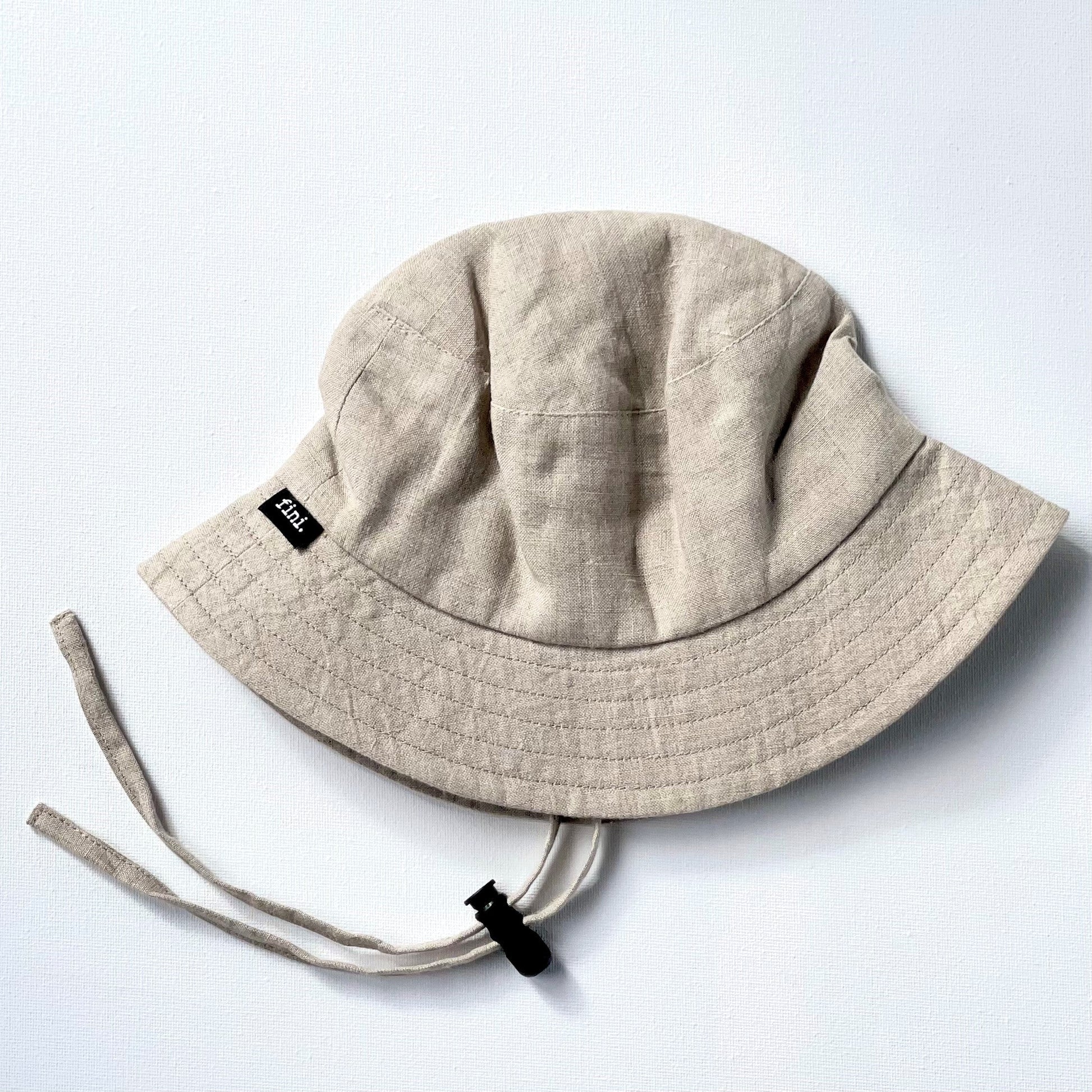 WS_available now_FINI. HAT: fini. bucket hat - linen-fini. the label