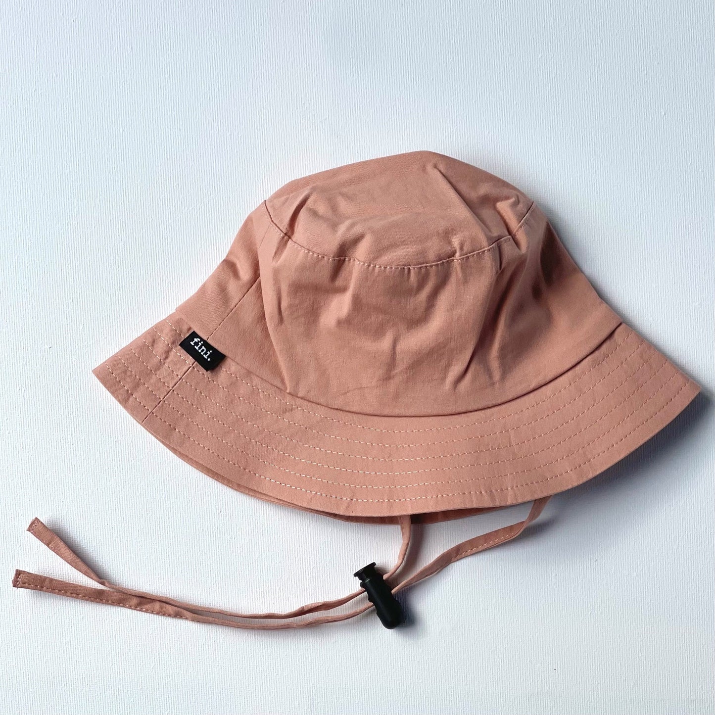 WS_available now_FINI. HAT: fini. bucket hat - pink-fini. the label