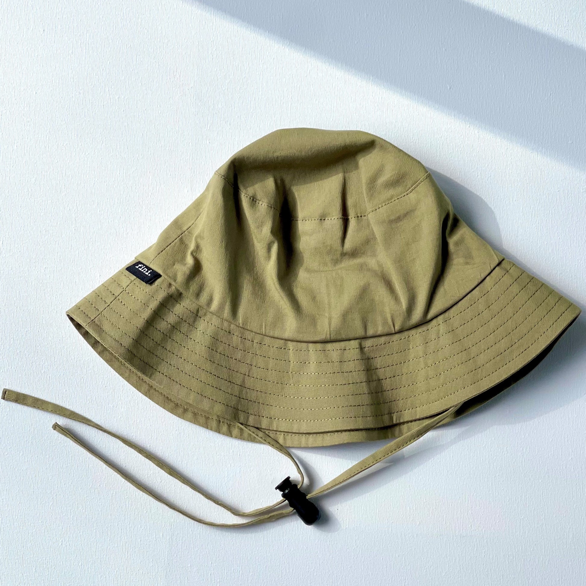 WS_available now_FINI. HAT: fini. bucket hat - sage-fini. the label