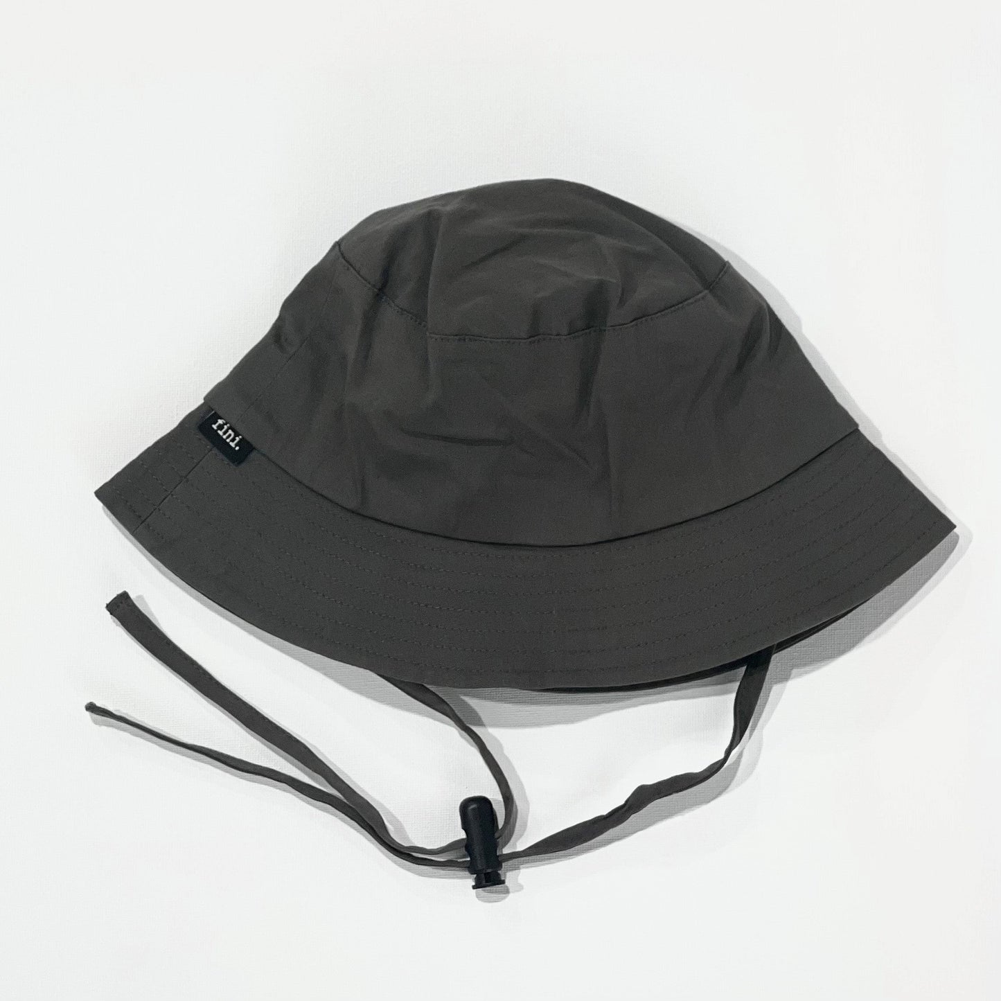 WS_available now_FINI. HAT: fini. bucket hat - coal-fini. the label
