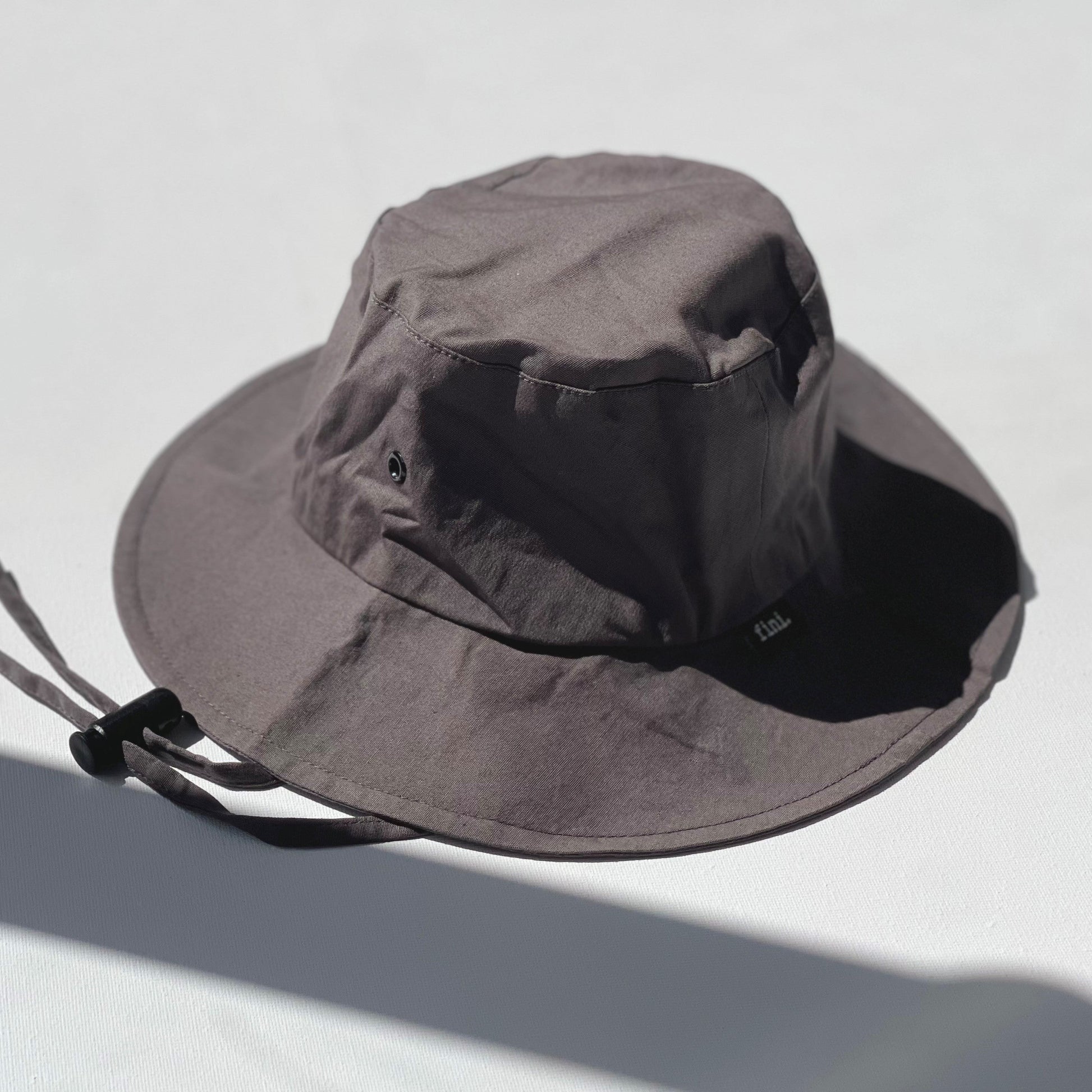 WS_available now_FINI. HAT: fini. relaxed bucket hat - coal-fini. the label