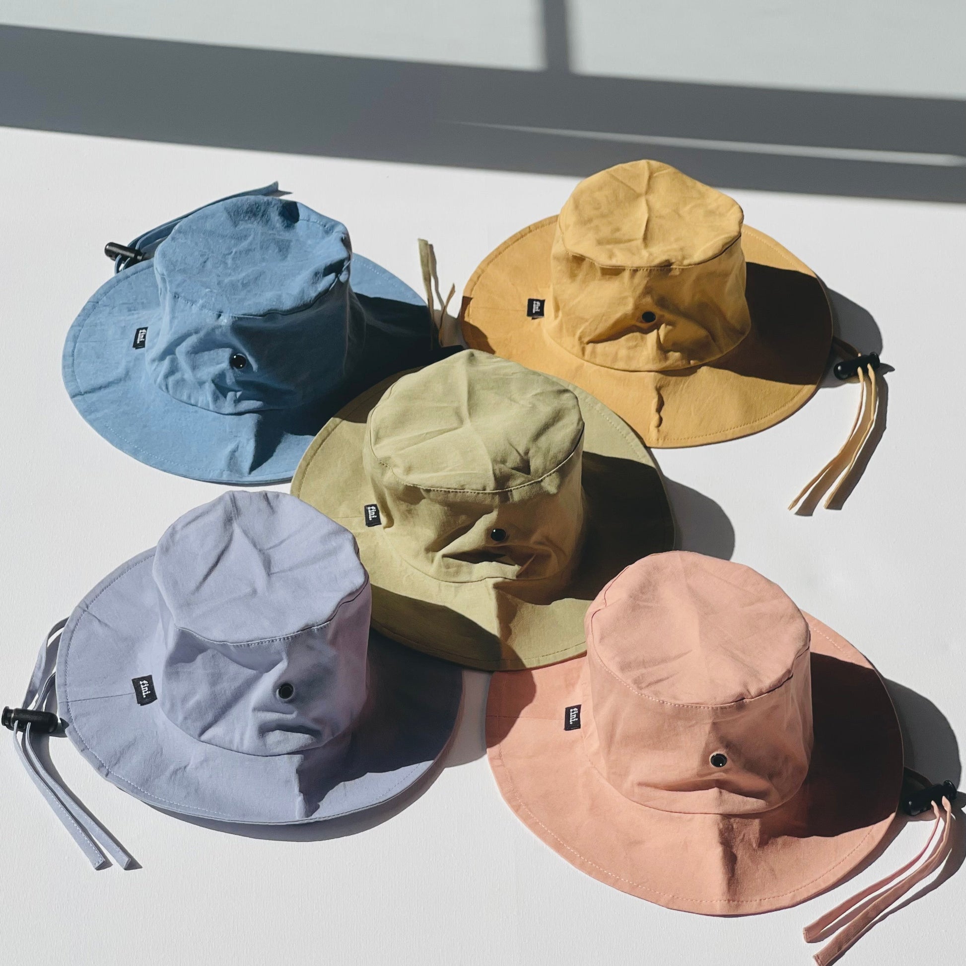 WS_available now_FINI. HAT: fini. relaxed bucket hat - denim-fini. the label