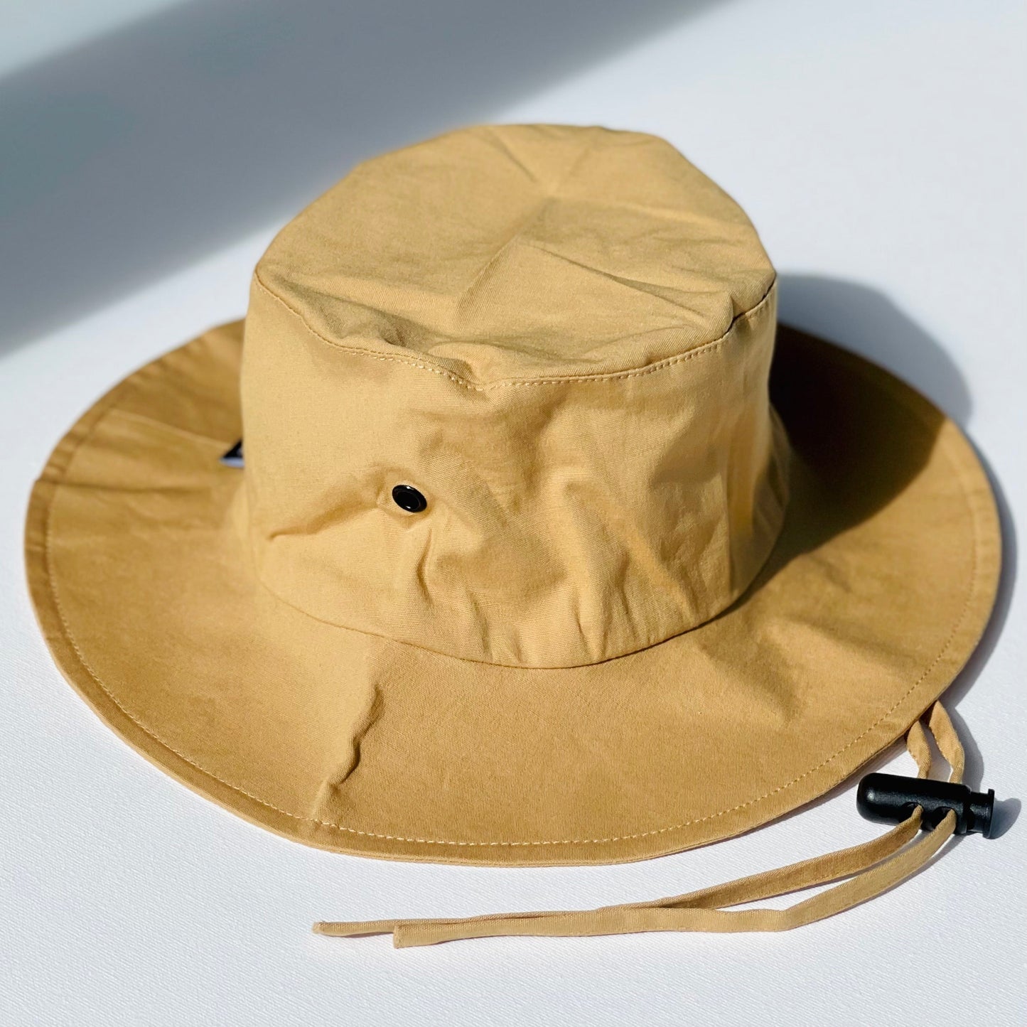 WS_available now_FINI. HAT: fini. relaxed bucket hat - gold-fini. the label