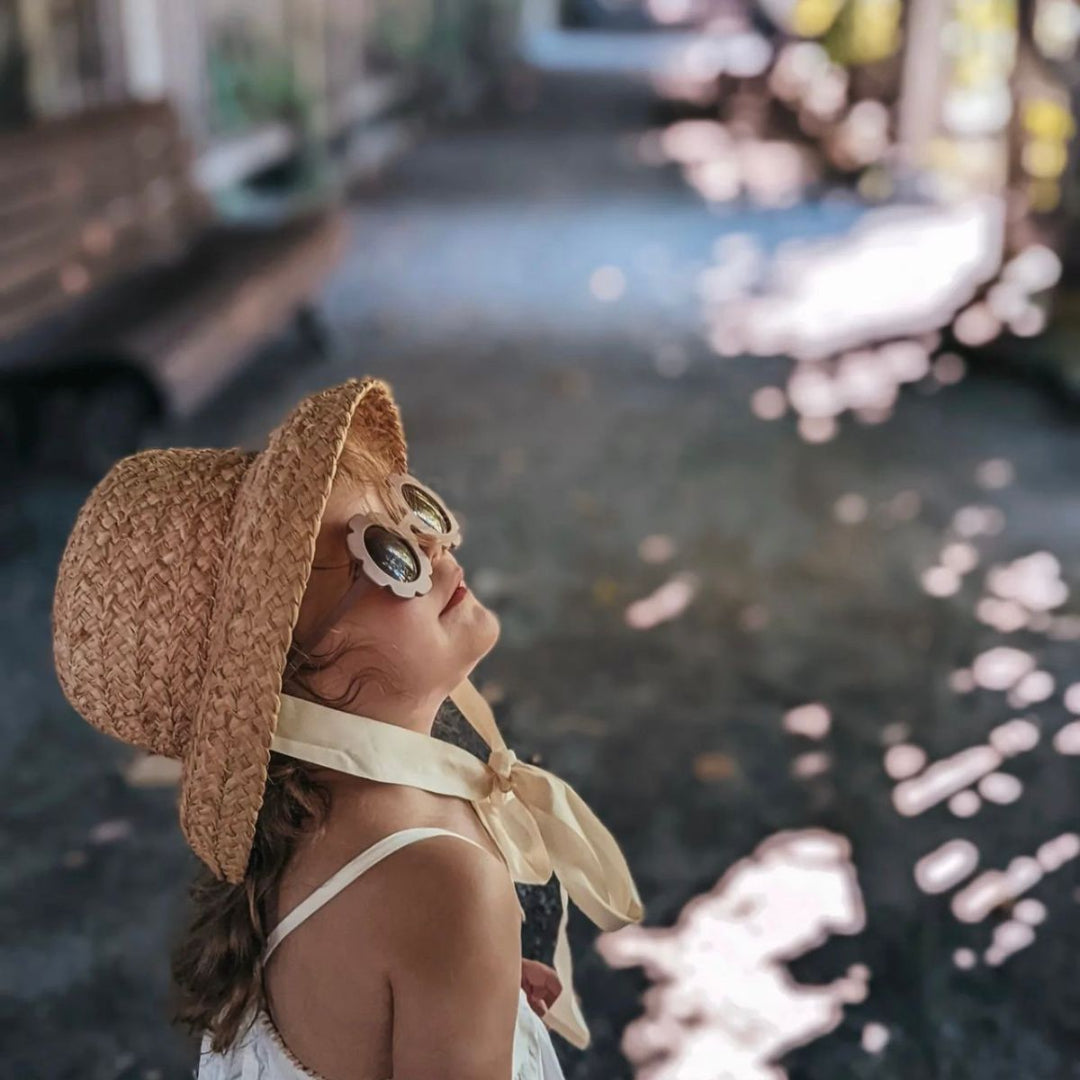 fini. the label vintage straw hat on girl aged 4 wearing neutral outfit