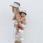 mother and daughter wearing fini. palm visor light beige matching set