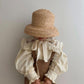 girl posing in fini. vintage straw hat elegant fashion statement look