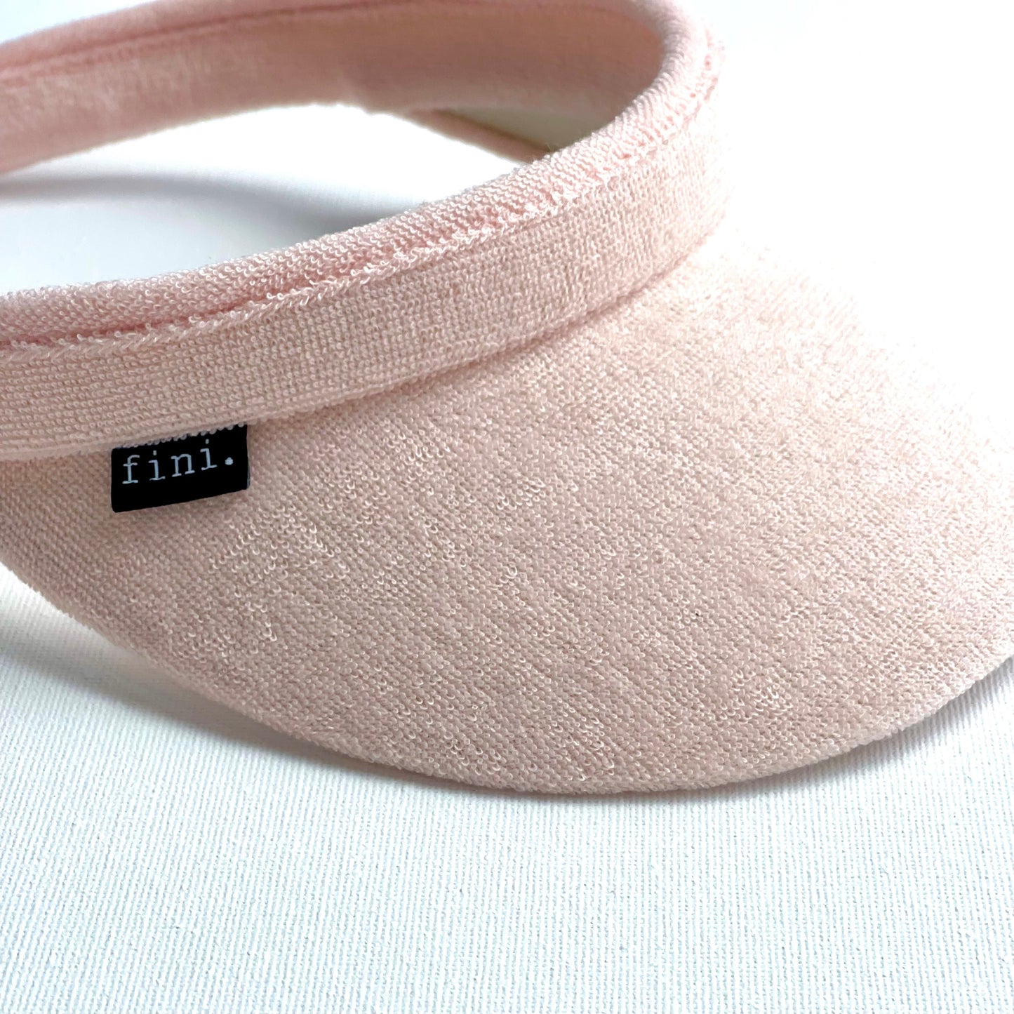 fini. towelling visor-fini. the label